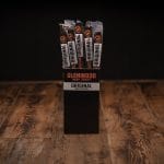 Glenwood Original meat sticks display box on a rustic wood table with individually wrapped sticks.