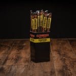Glenwood beef jerky teriyaki meat stick display box against dark backdrop.