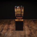 Glenwood Honey Habanero meat sticks display box on rustic wood table with individually wrapped sticks.