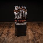 Glenwood Original meat sticks display box filled with individually wrapped beef sticks on wooden surface.