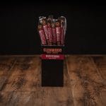 Glenwood Pepperoni meat sticks display box on a rustic wood table with individually wrapped sticks.