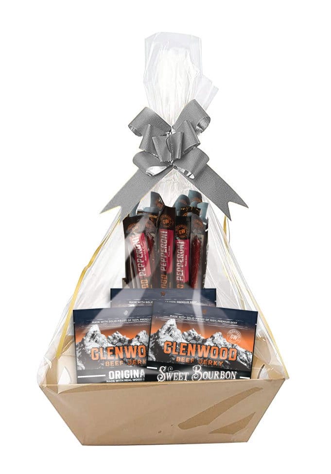 Glenwood Beef Jerky gift basket with assorted jerky and meat sticks, wrapped in cellophane with a silver bow.