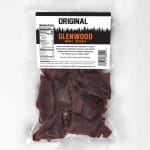 Back view of Glenwood Original beef jerky package with nutrition facts, barcode, and dark jerky pieces visible.