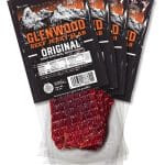 Glenwood Original Beef Jerky Slab 12-pack with mountain design packaging and visible jerky pieces.