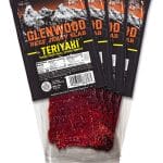Set of twelve Glenwood Teriyaki Beef Jerky Slabs in black packaging made with real wood smoke.